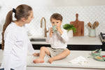 Toddler wearing clear disposable bib during meal at home